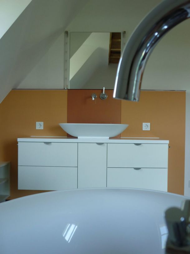 Saniertes Badezimmer in orange und weiß gehalten.